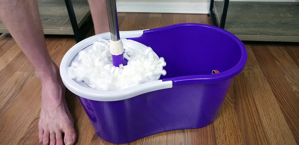 Wrining out the cleaning pad on the Goplus is completed by manually spinning the mop