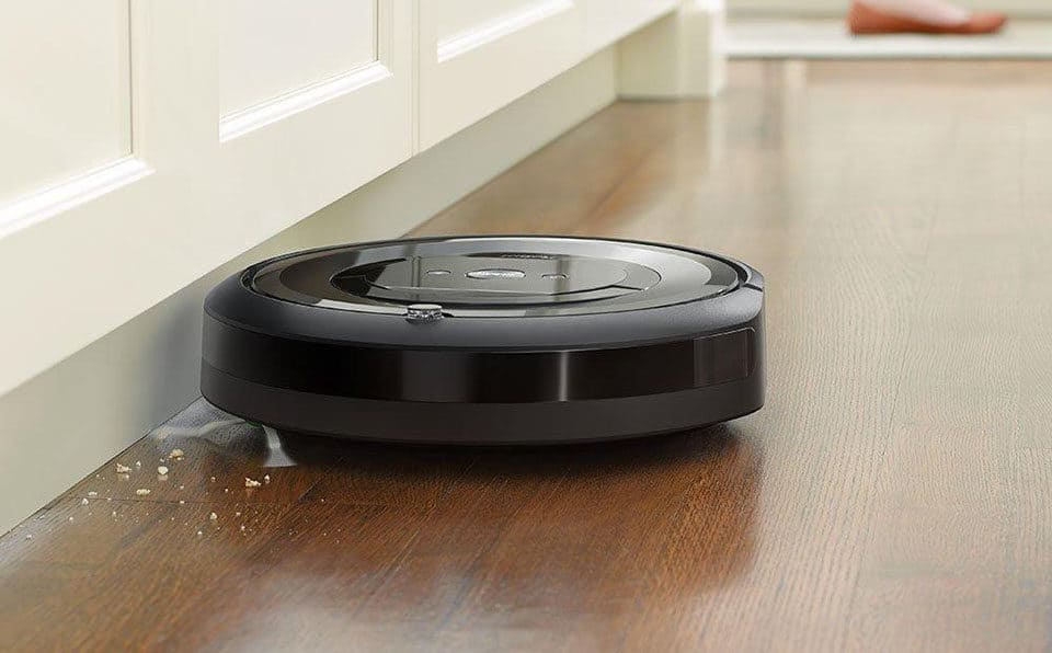 The Roomba e5 uses its spinning brush to clean up against edges, sweeping debris into its path